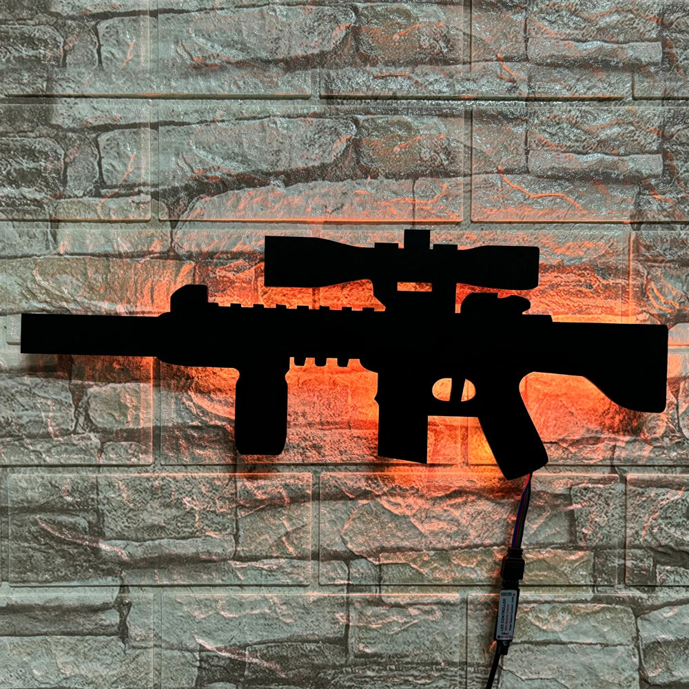 A black gun-shaped LED light mounted on a stone wall, illuminated with an orange glow.