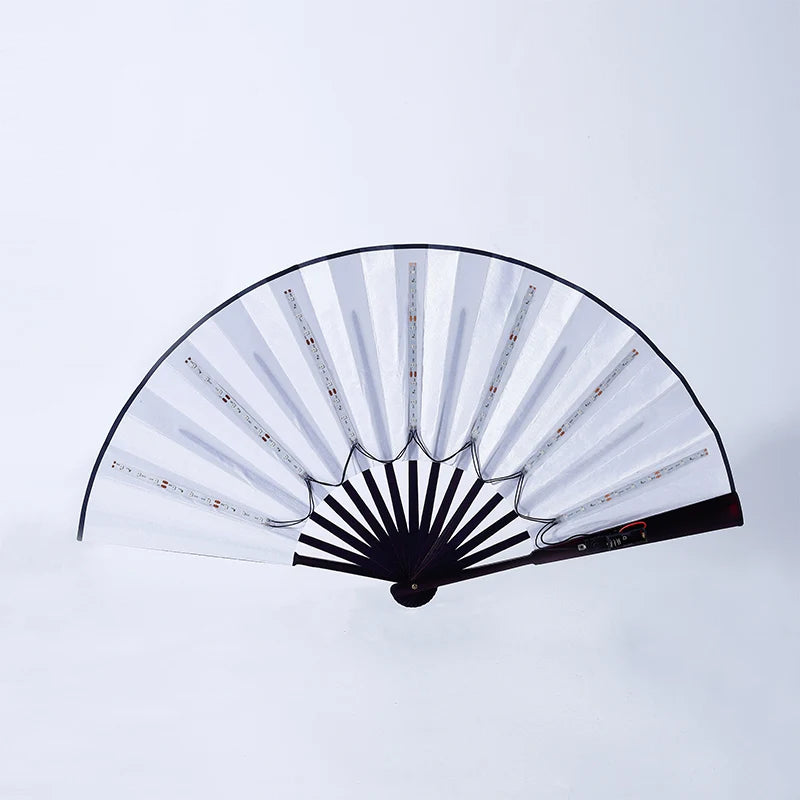 An illuminated folding hand fan with black and clear blades showing light accents.
