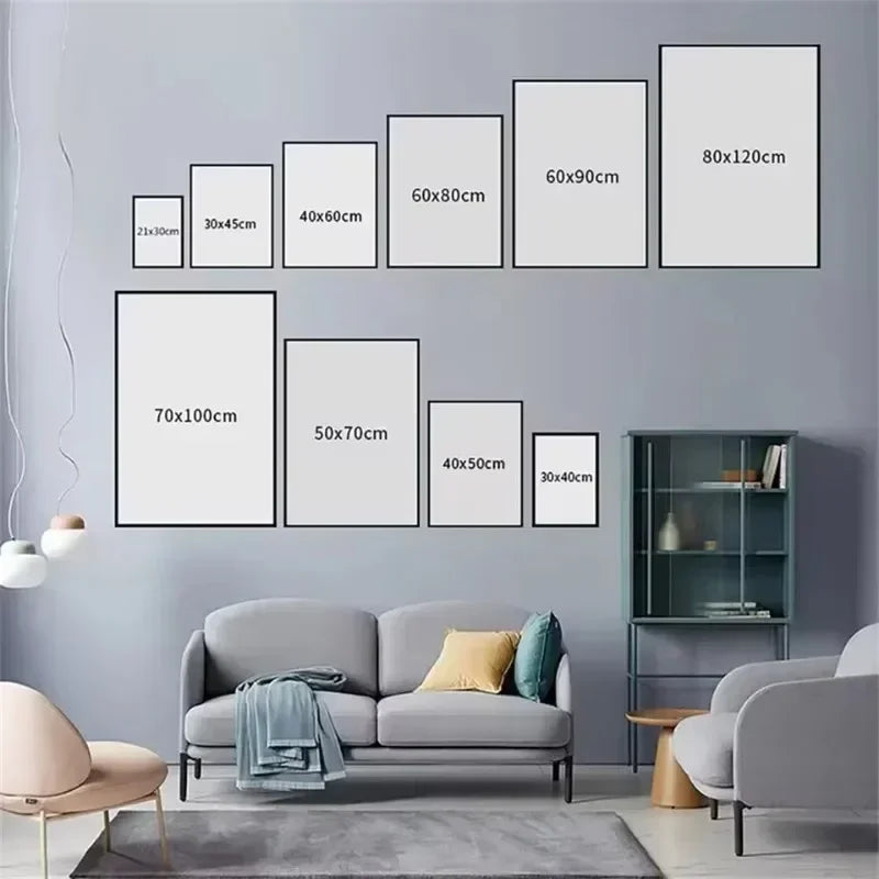 A set of nine framed canvas wall art prints in various sizes displayed on a gray wall above a modern sofa.