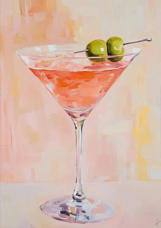A pink cocktail in a martini glass garnished with two green olives, set against a light background.