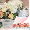 A pink and cream floral arrangement displayed in an acrylic rectangular vase with multiple openings.