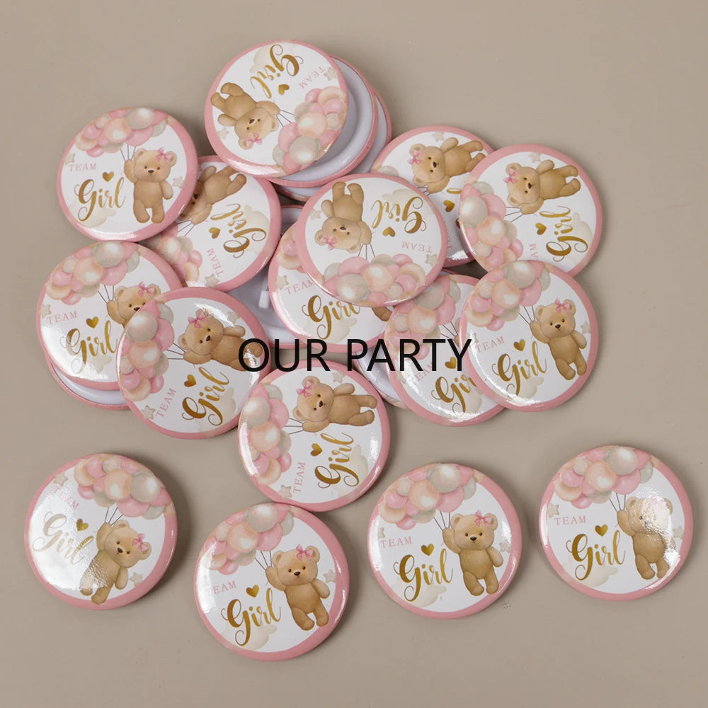 A collection of round pin badges featuring cartoon bears for gender reveal and baby shower parties