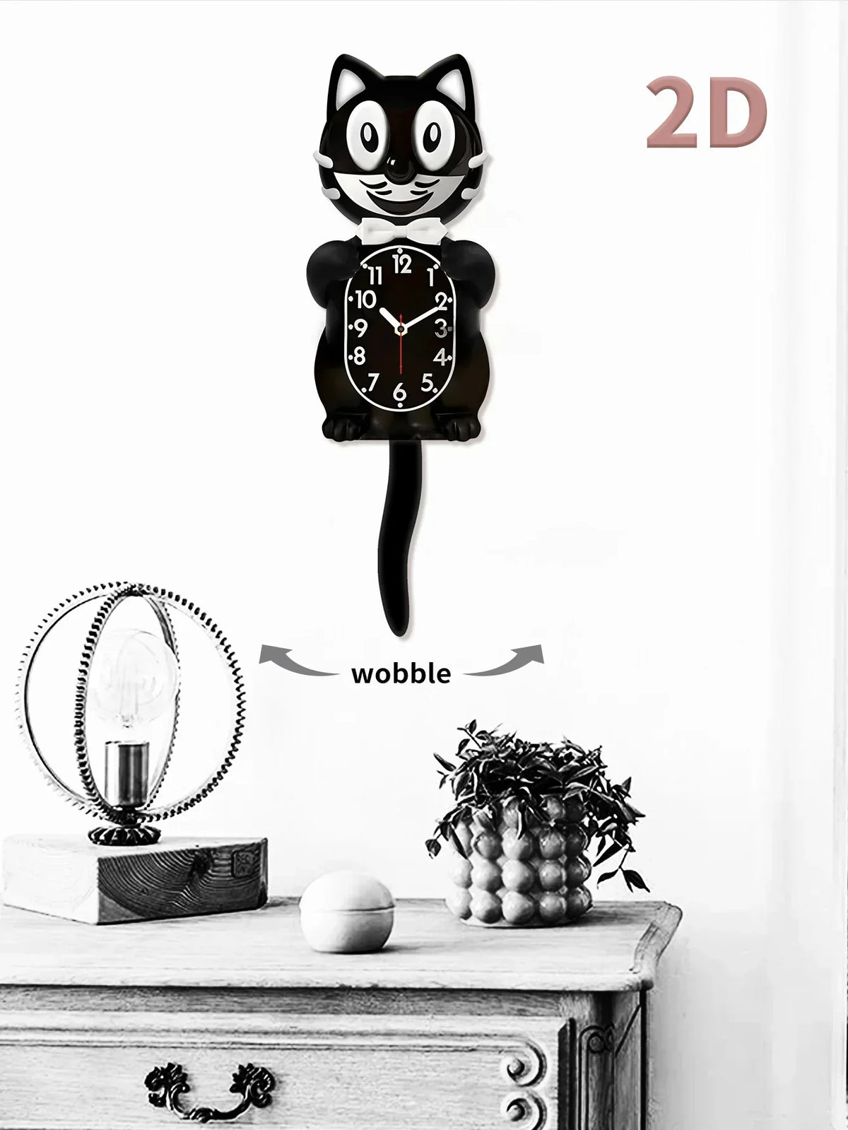 A black cartoon cat wall clock with a swinging tail is displayed on a wooden surface.