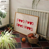 Minimalist chef heart canvas wall art featuring red hearts on a white background displayed above a radiator.