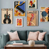 A gallery wall featuring abstract paintings of a guitar, cello, and piano on a gray wall above a sofa.