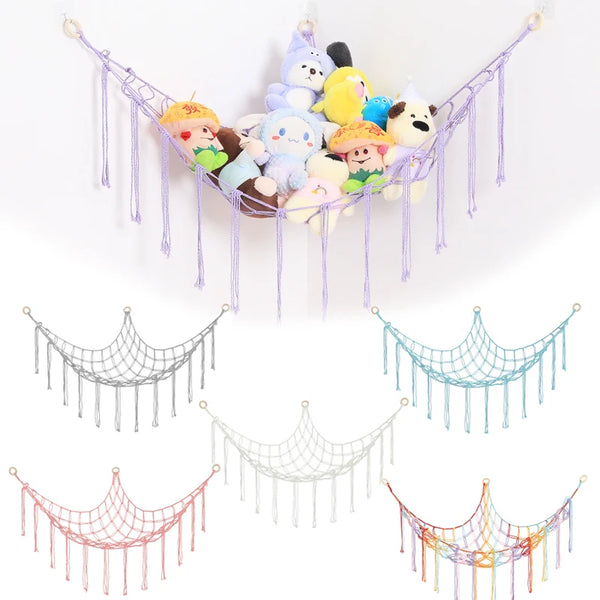 A colorful cotton hammock featuring various stuffed animals and plushies hanging from a light-colored frame.