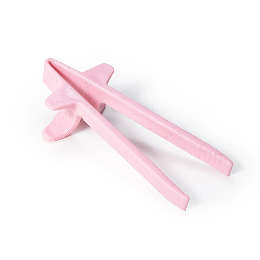 Pink reusable wheat straw finger chopsticks shown against a white background.