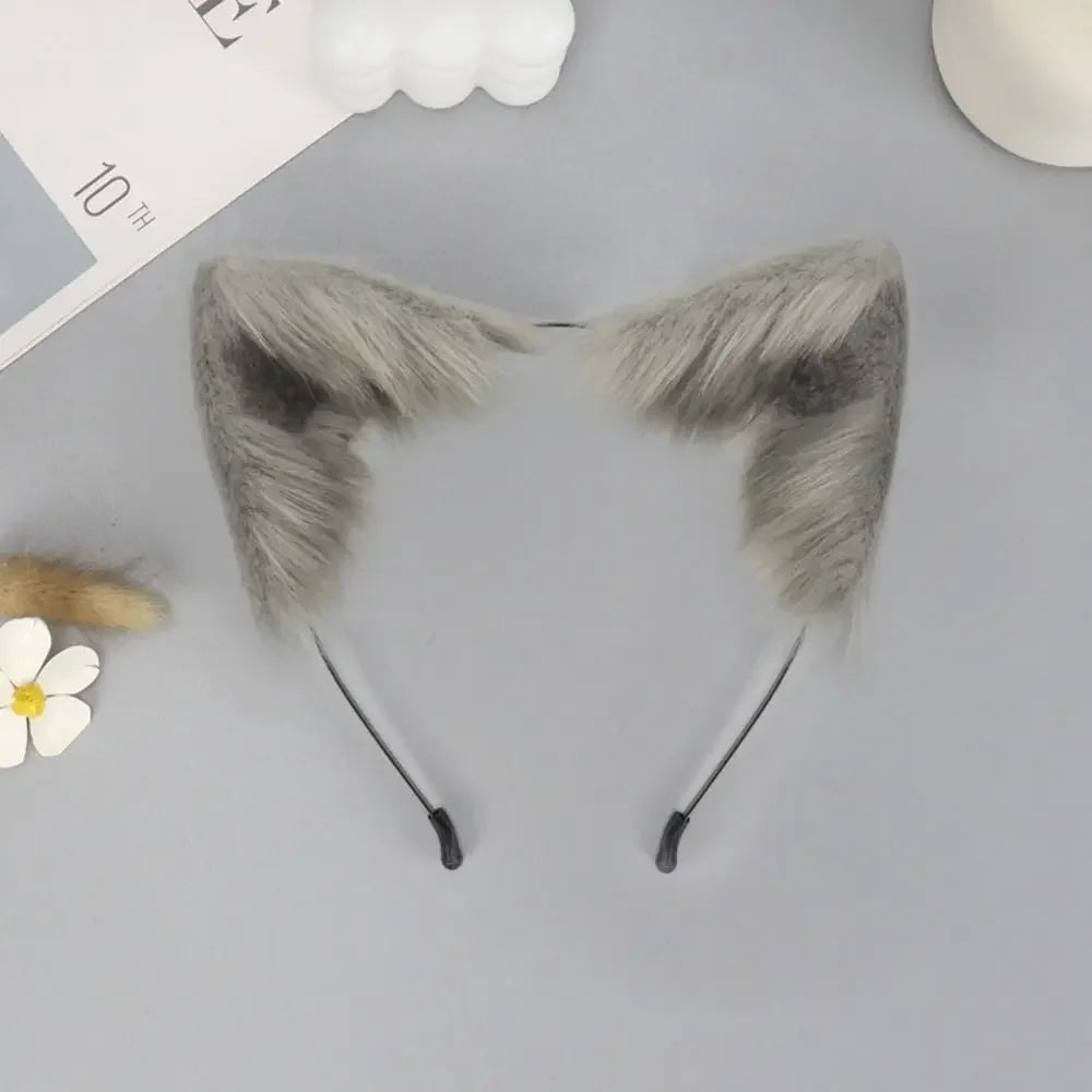 A pair of gray plush fox ears headband with thin black ties displayed on a light gray background.