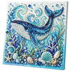 Diamond painting featuring a blue whale and various sea creatures made of pearls and jewels