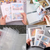 A hand holds an open photo album featuring colorful cards and transparent holders for collecting photos.