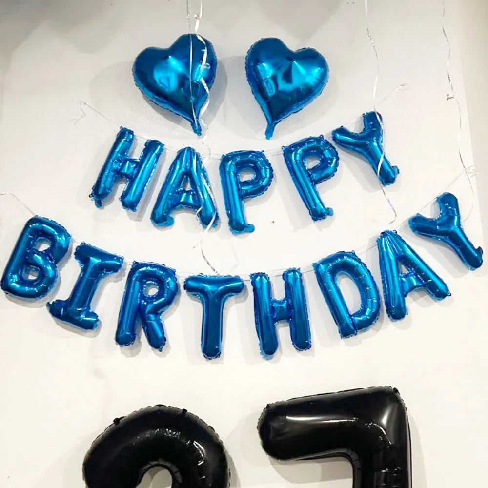 A display of blue and silver foil letter balloons spelling out HAPPY BIRTHDAY for a celebration.