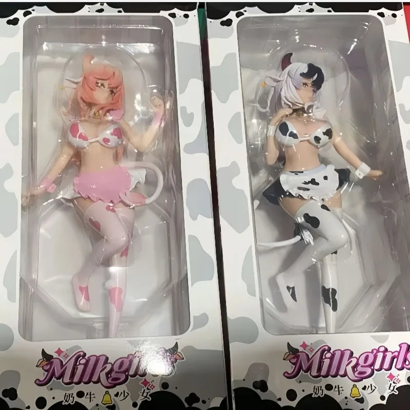 A set of two adorable cow-girl miniature figures, one pink and one white, displayed in clear plastic packaging.