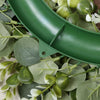 A green artificial eucalyptus wreath featuring a curved sign or banner.