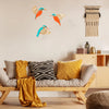 Three vintage wooden bird wall decorations featuring orange and blue colors displayed on a light wall.