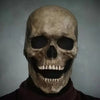 A realistic human skull mask with a wide grin, used for Halloween costumes.