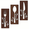 A set of three wooden utensils, including a fork, spoon, and knife, carved into decorative shapes for wall display.