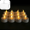 A set of round white flameless LED tealight candles with warm white flicker displayed on a dark surface.