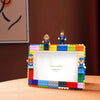 A DIY building block photo frame kit featuring minifigures and a white display area.