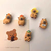 A set of adorable guinea pig refrigerator magnets in various shades of brown and gold.