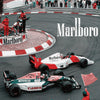 A vintage F1 Monaco racing canvas art print featuring a race car and pit crew on the track.