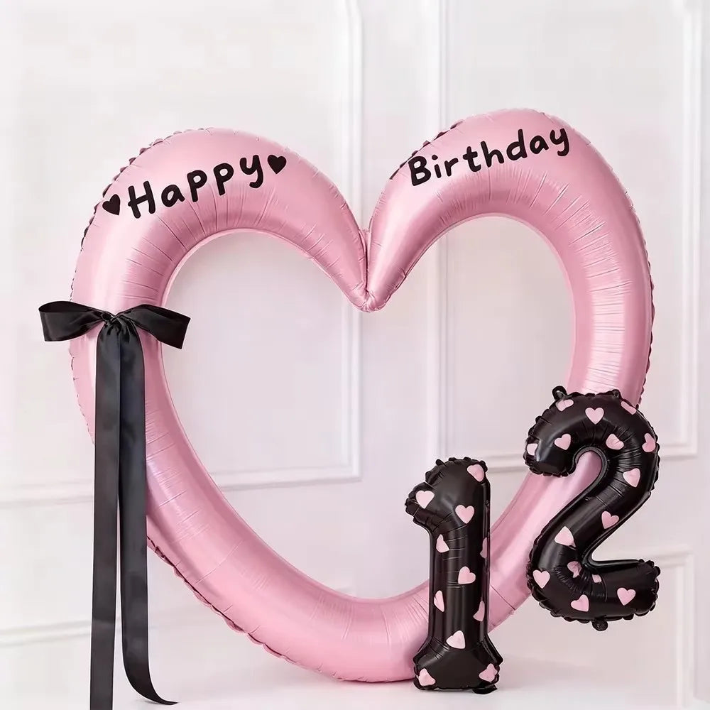 Pink heart-shaped balloon decoration with Happy Birthday text and a large number 2