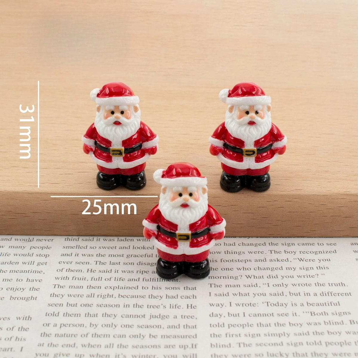 A set of festive Christmas resin decor featuring two Santa figures with white beards and red suits.