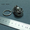 A silver alloy gun model miniature keyring is shown next to a ruler, with a scale indicating its size of 4cm.