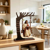 A wooden desk ornament depicting Jesus reading a Bible in a tree branch.