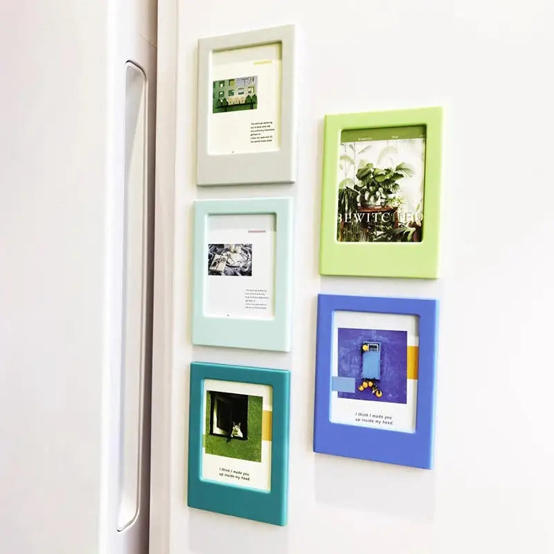 A set of five decorative photo frames in various shades of green and blue mounted on a white surface.