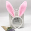 Pink bunny ear headband with white fur and a decorative silver frame.