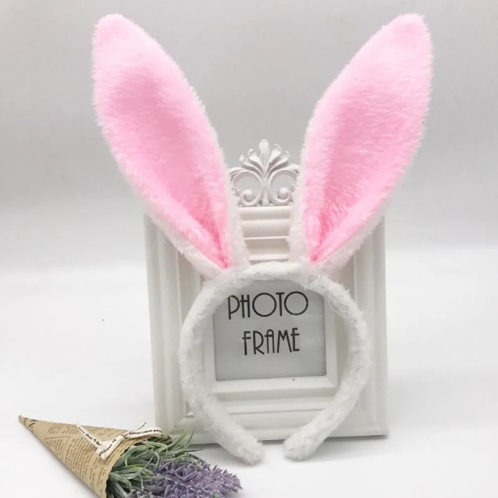 Pink bunny ear headband with white fur and a decorative silver frame.