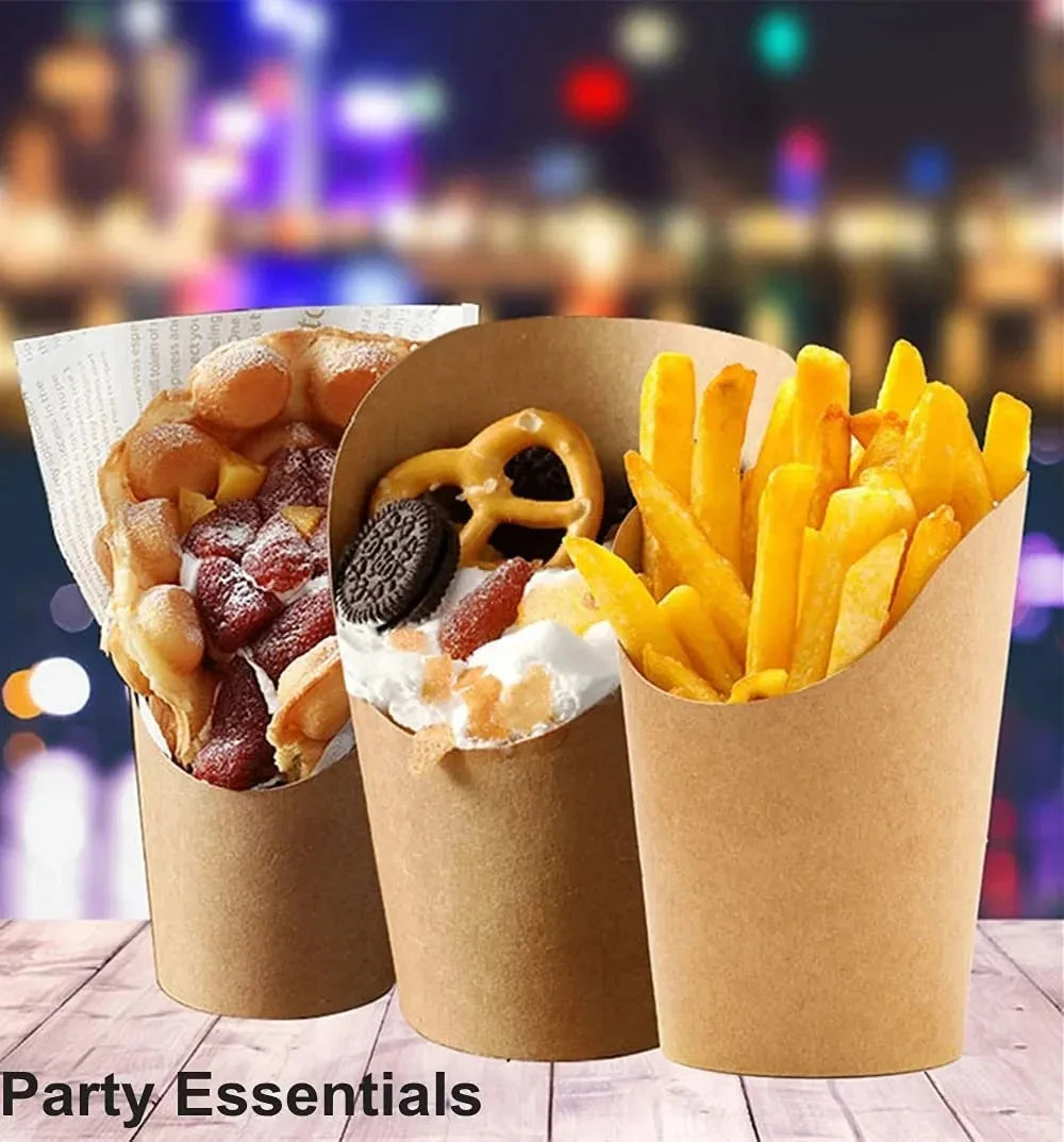 A close-up of several disposable kraft paper cups filled with french fries and toppings, set against a blurred city night bac