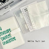 White full set of A5 100-envelope savings challenge binder with numbered pockets and a matching leather notebook.