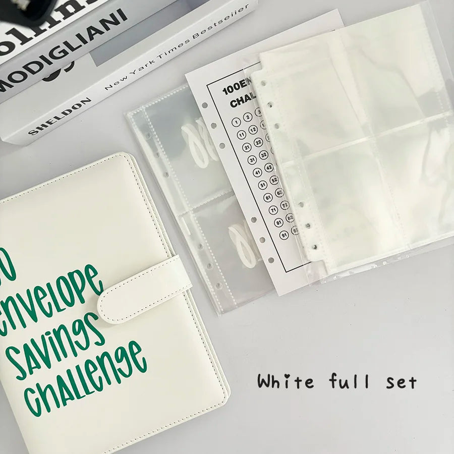 White full set of A5 100-envelope savings challenge binder with numbered pockets and a matching leather notebook.