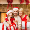 A family of three smiling in front of a rustic stone fireplace with Christmas decorations and gifts.