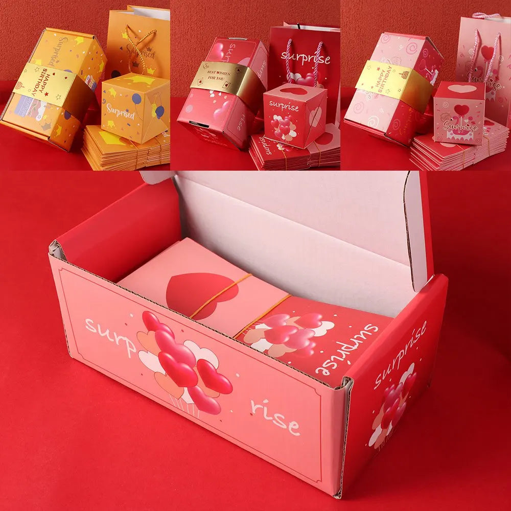 A pink luxury pop-up surprise gift box with a lid open, surrounded by other colorful gift boxes.