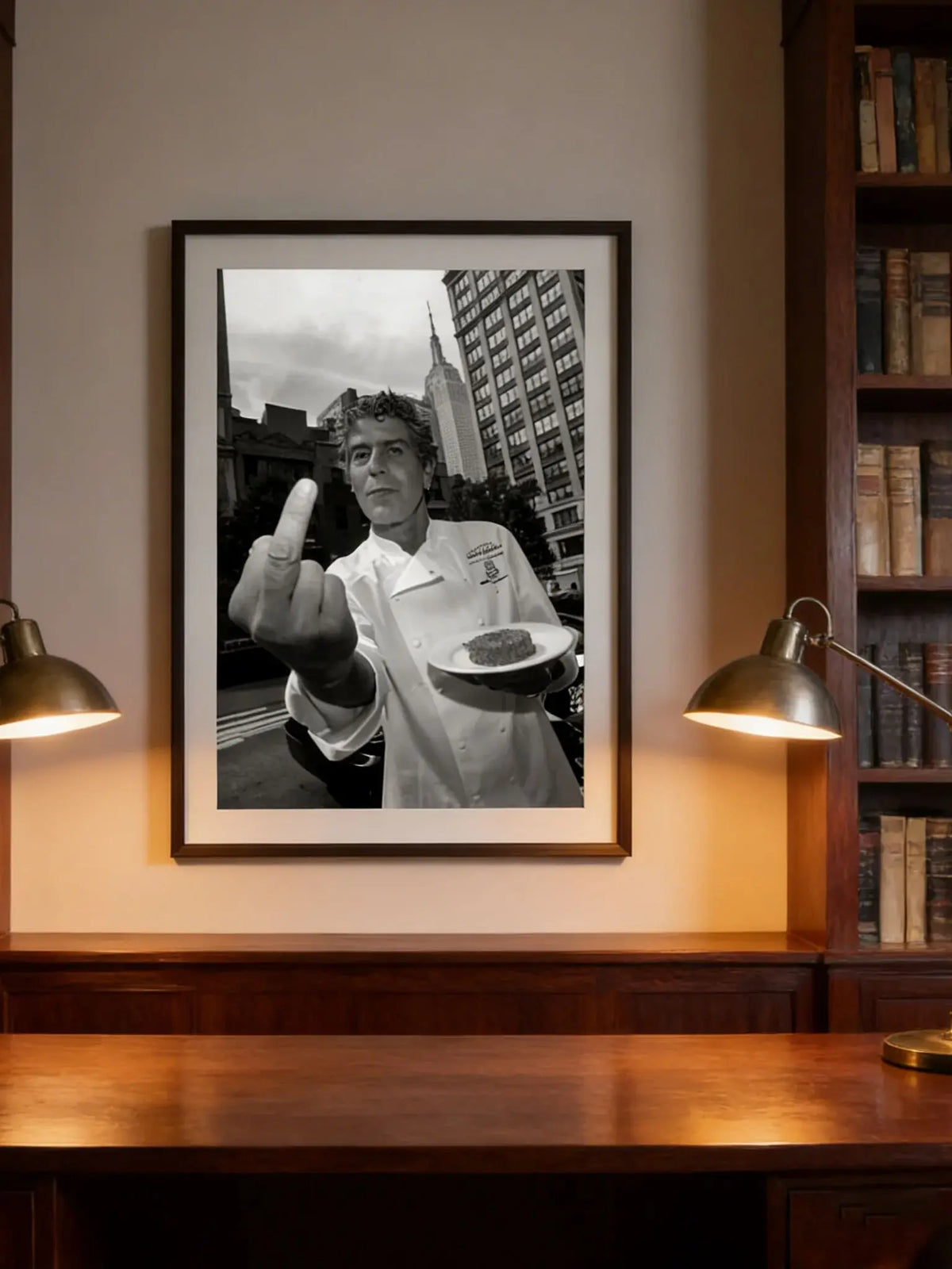 Black and white photograph of a man making a peace sign in a chef's coat displayed in a framed print.