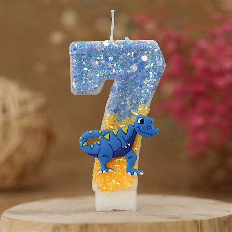 A birthday candle shaped like the number 7 covered in blue glitter and featuring a small dinosaur figure.