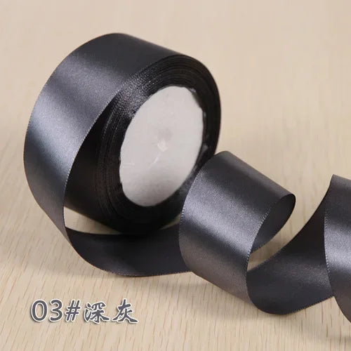 Roll of black silk satin ribbon for gift wrapping and craft projects