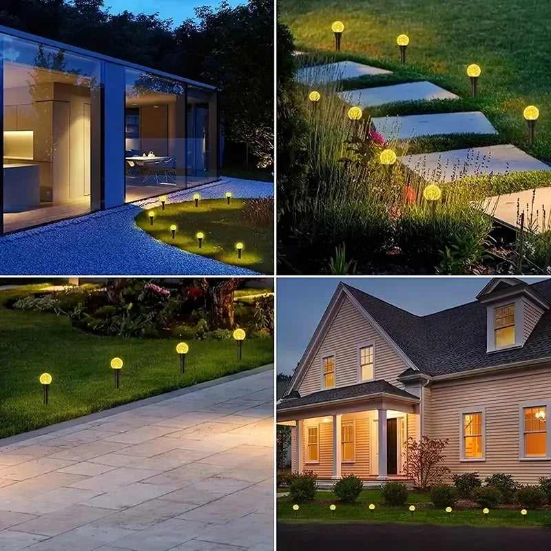 A set of solar powered bubble ball garden lights illuminating a landscaped garden pathway and lawn.