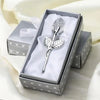 A silver crystal rose artificial flower displayed in a decorative box with white tissue paper.