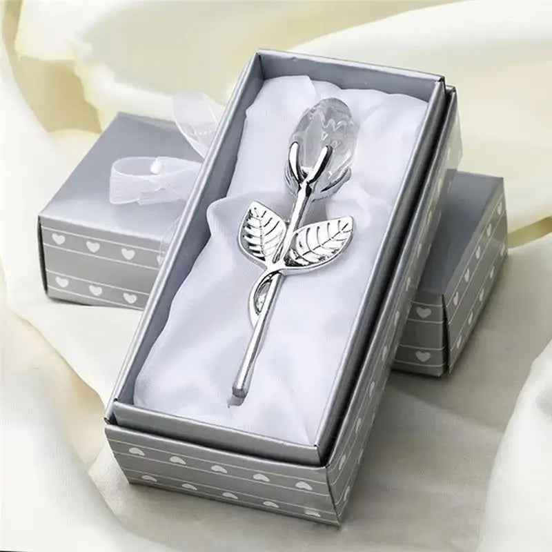 A silver crystal rose artificial flower displayed in a decorative box with white tissue paper.