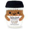 Handwoven knitted coffee cup cozy with a brown doll decoration and text reminding to be enough