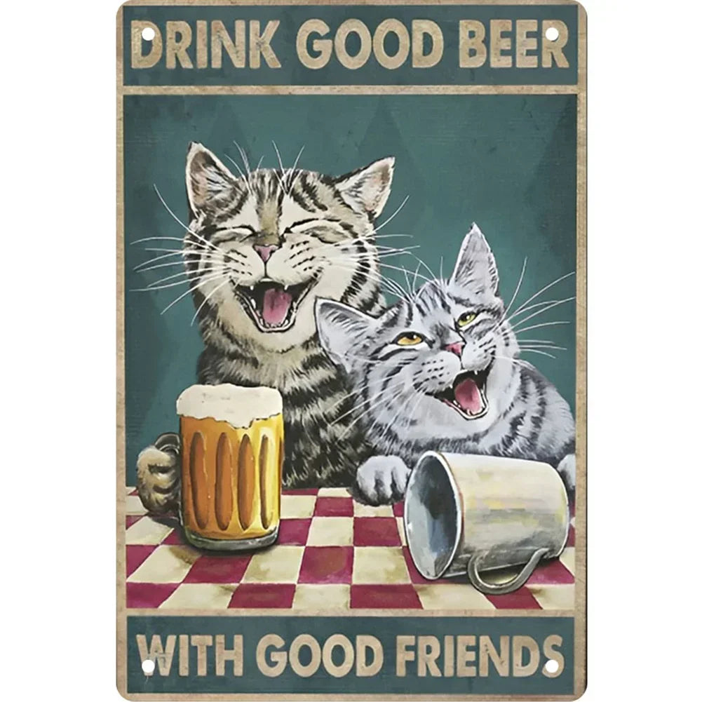 A vintage metal sign featuring two cats drinking beer with the text Drink Good Beer with Good Friends
