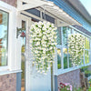 A white artificial morning glory hanging vine decor is displayed outside a door with glass panels.