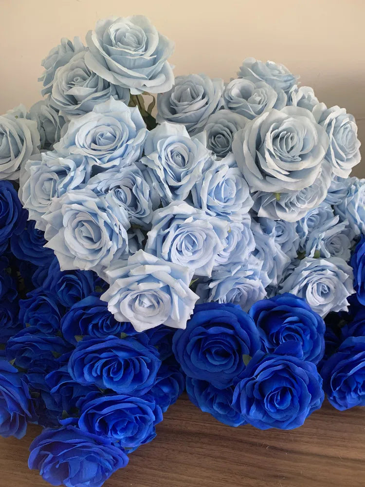 A bouquet of silk roses in various shades of blue, including light blue and deep blue.