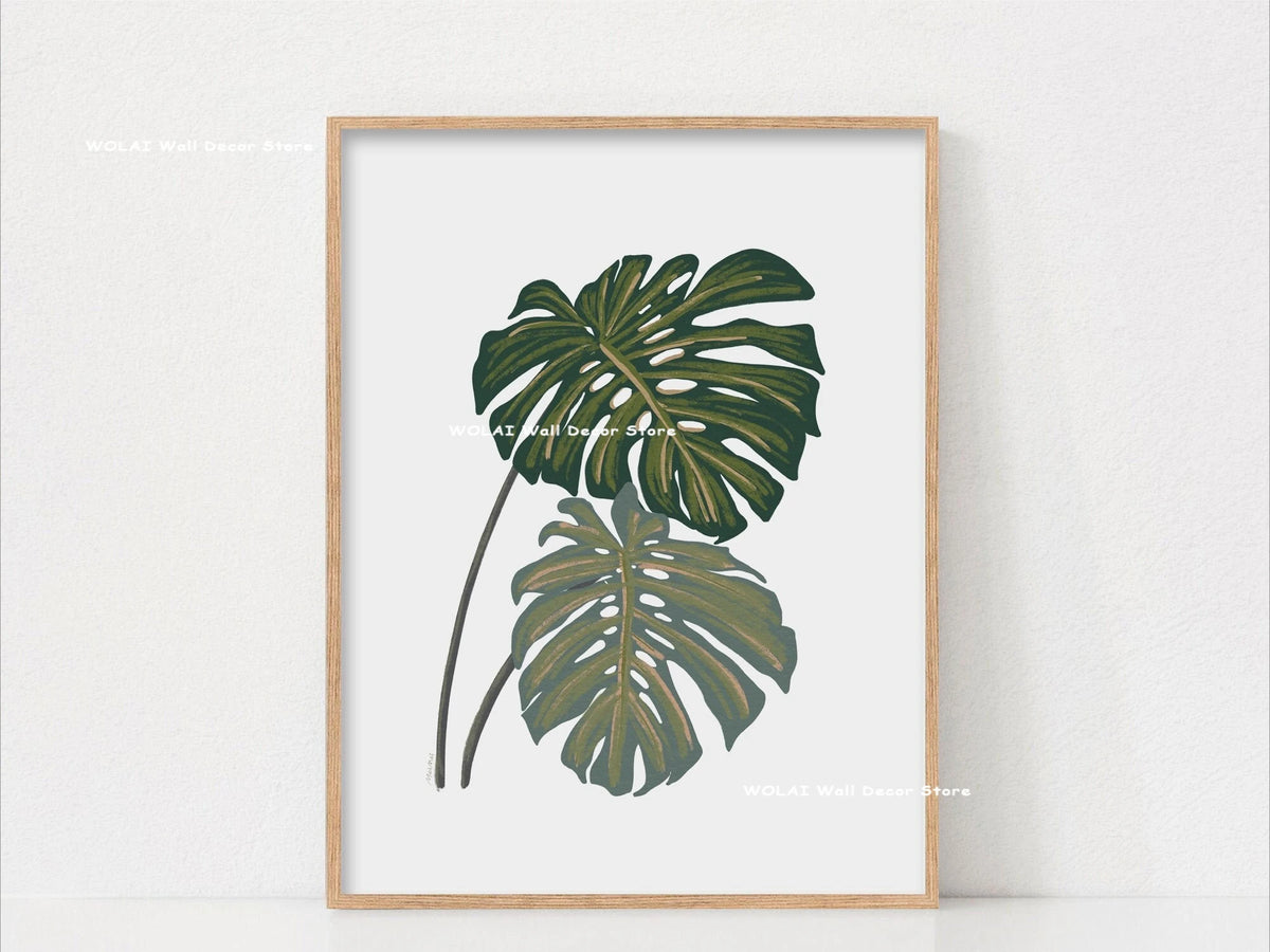 Botanical Philodendron canvas wall art featuring large green leaves framed in light wood.