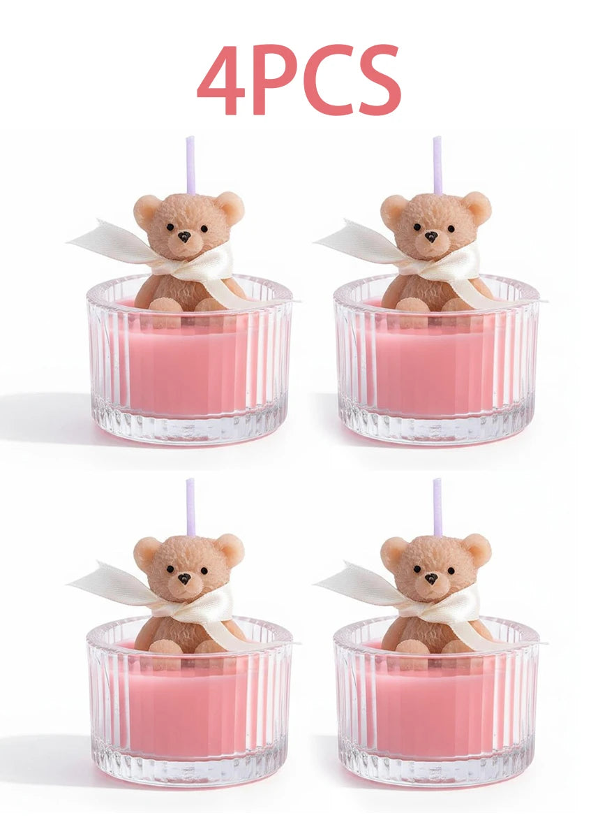 Four soy wax teddy bear candles in glass jars with ribbons