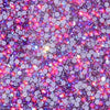 A close-up of hotfix glass rhinestones in various colors and sizes, including purple, blue, green, and yellow.