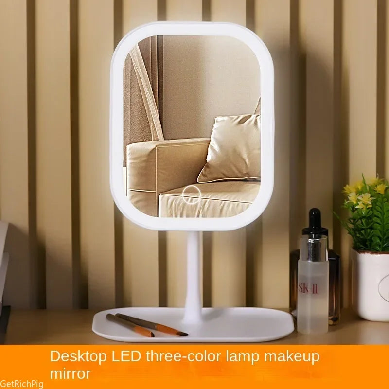 A white LED three-color lamp makeup mirror standing on a flat base in a neutral indoor setting.